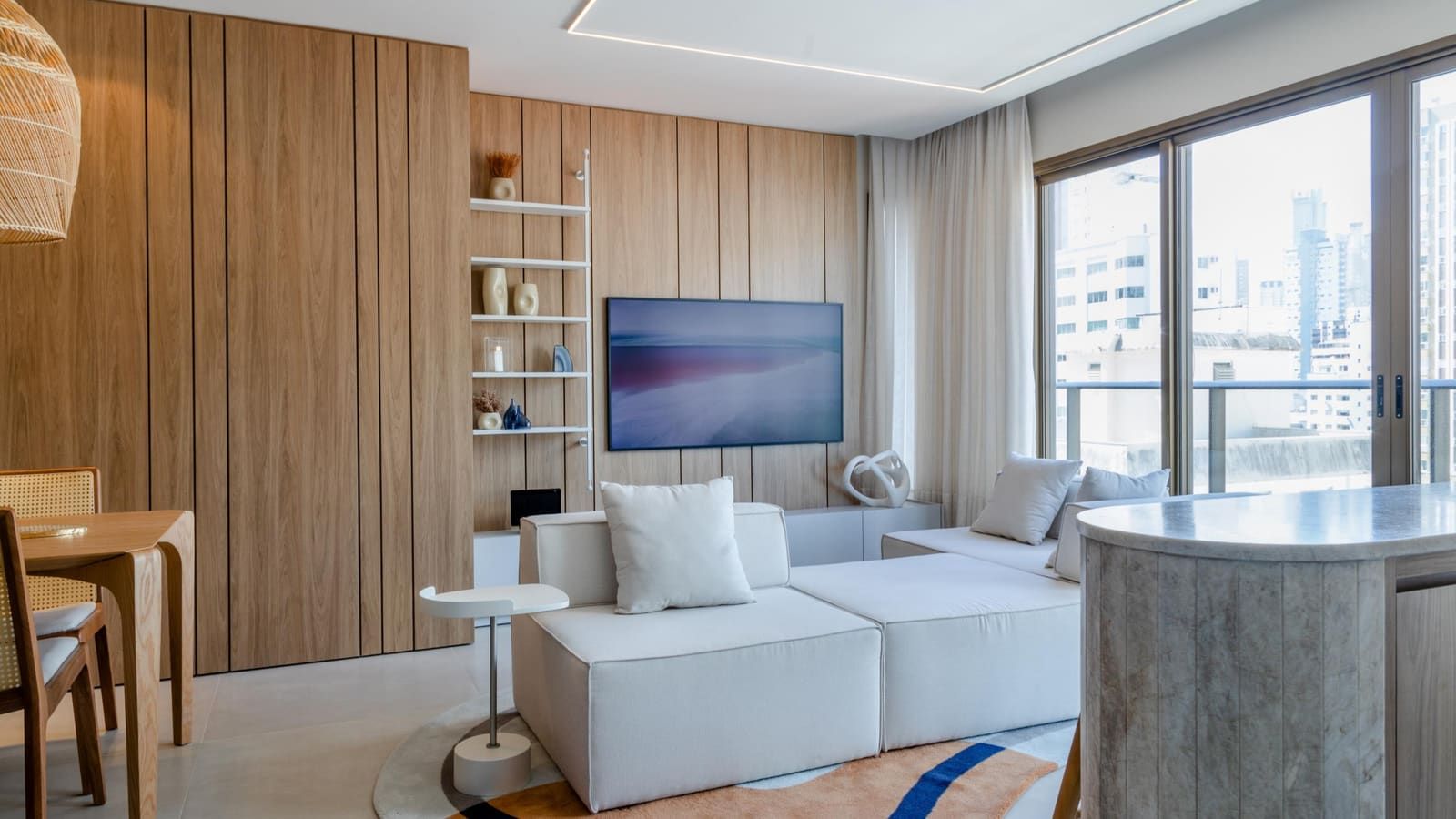 Living room with full-height wood paneling around a media wall and open shelving